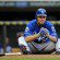 Eric Hosmer sits on the ground after making an out.