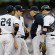 New York Yankees players and pitching coach meet on the mound.