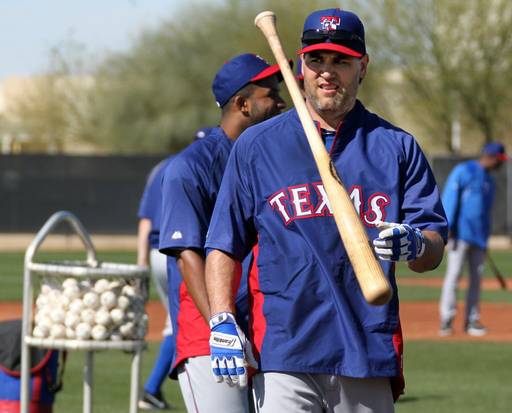 Lance Berkman flips a bat in spring training for the Texas Rangers