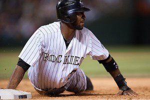 Colorado Rockies CF Dexter Fowler looks up after diving back to first base.