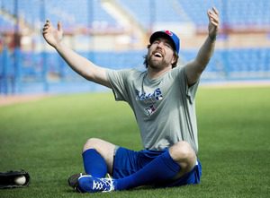 R.A. Dickey sitting on the grass during spring training for the Toronto Blue Jays.