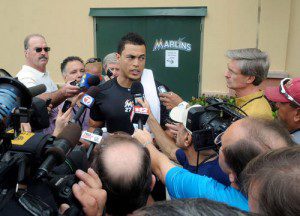 Reporters surround Giancarlo Stanton during a spring training press conference.