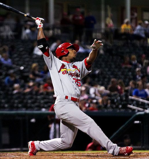 Oscar Taveras takes a swing and watches.