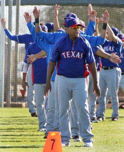 Adrian Beltre heads a line of Texas Rangers during spring training drills.