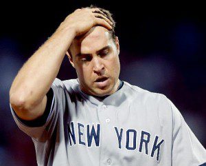 New York Yankees first baseman Mark Teixeira runs his hand through his hair.