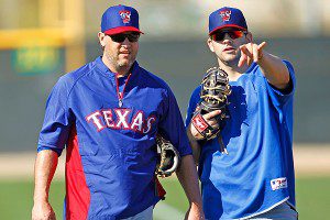 Texas Rangers Lance Berkman and Mitch Moreland chat during spring training drills.