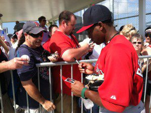 Jackie Bradley Jr. signs autographs during spring training for the Boston Red Sox.