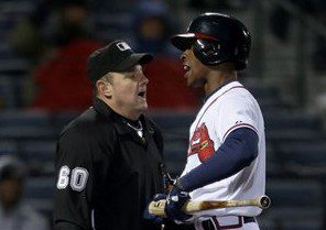 Atlanta Braves batter B.J. Upton talks to an umpire after striking out.