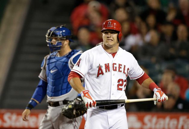 Mike Trout holds his bat in his hand with a strange look on his face after striking out against Yu Darvish.