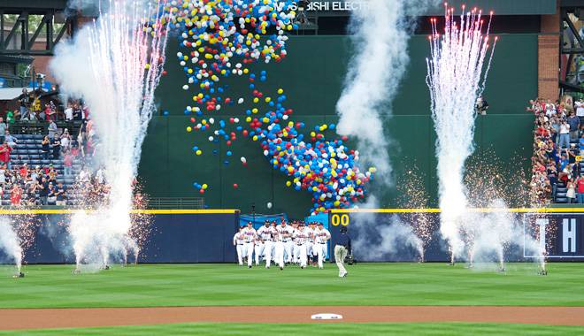 Atlanta Braves players enter the field from center field amidst fireworks on opening day.