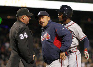 Atlanta Braves manager Fredi Gonzalez chats with an umpire.