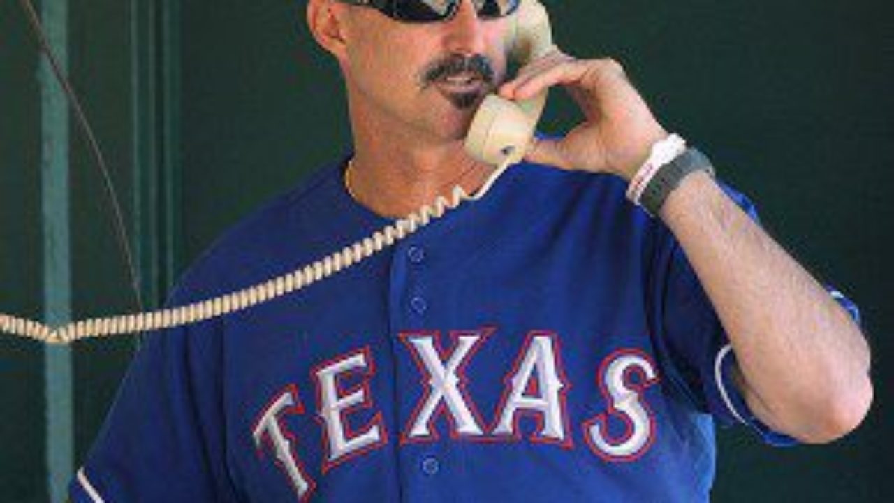 Now-former Washington Nationals' pitching coach Mike Maddux signs