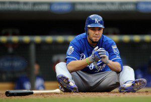 Eric Hosmer sits on the ground after making an out. 