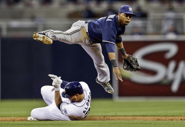 Jean Segura leaps over a sliding runner to complete a double play.