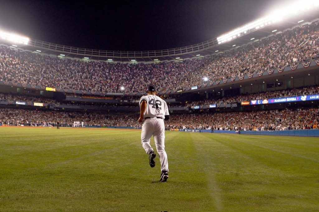 Mariano Rivera runs from the bullpen to the mound at Yankees stadium.