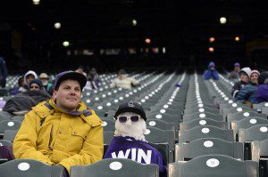 Fan sits in freezing cold, next to a snow man, in mostly empty Coors Field when the Atlanta Braves were in town.