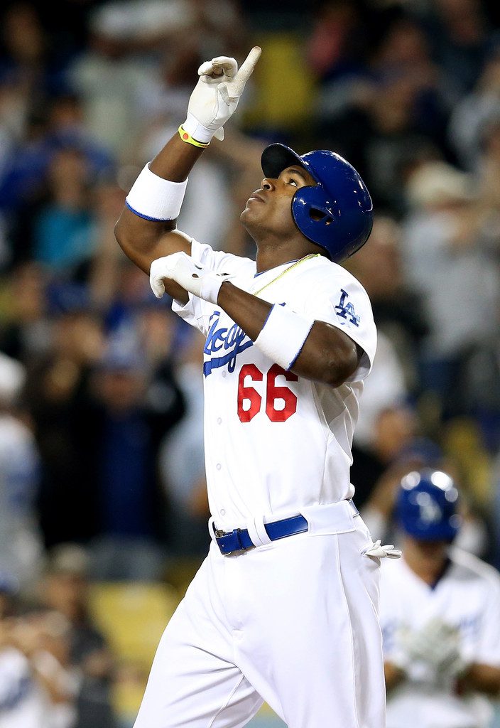 Yasiel Puig points to the sky after hitting a home run last night.