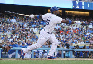 Yasiel Puig finishes his swing and watches the ball leave the park.