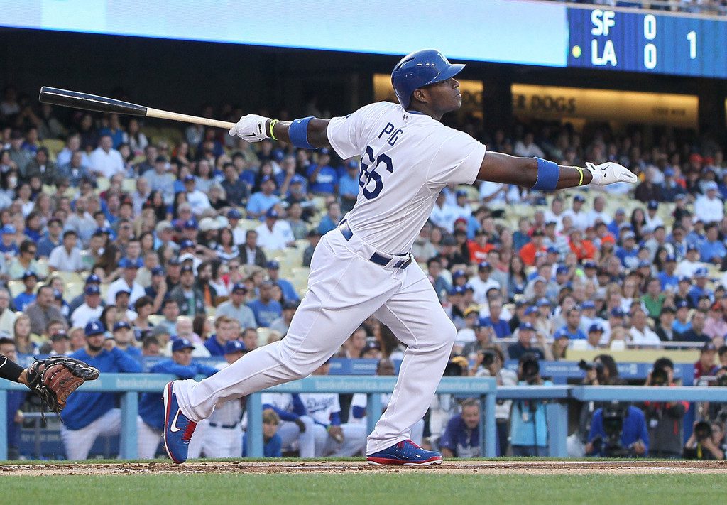 Yasiel Puig finishes his swing and watches the ball leave the park.