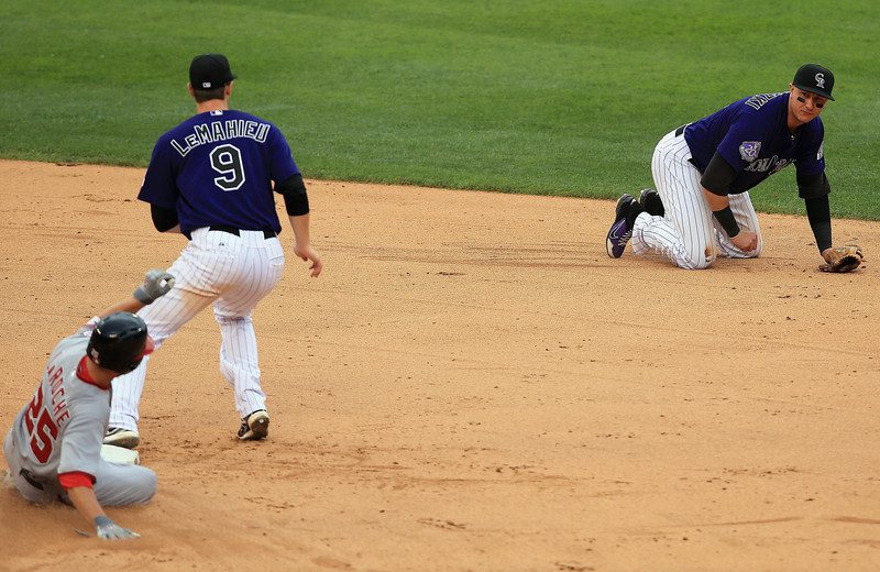 Troy Tulowitzki is down on all fours after stopping a ground ball.