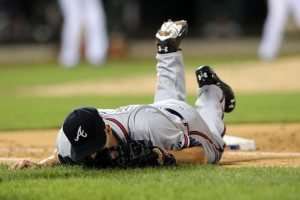 Tim Hudson falls to the ground after getting injured.