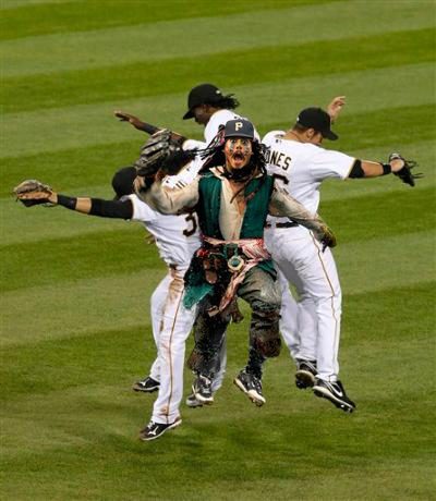 Composite image of Captain Jack Sparrow celebrating with the Pittsburgh Pirates after a win.