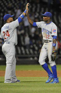 Chicago Cubs players high five after beating the White Sox.