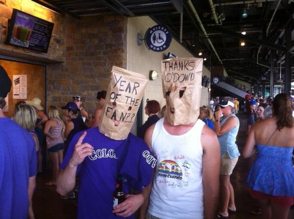 Rockies fans wearing paper bags over their heads.