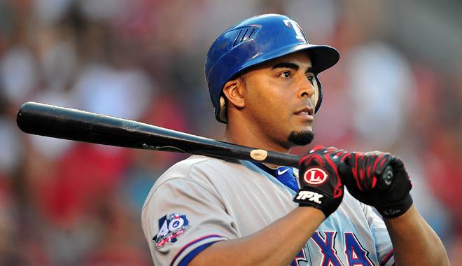 Nelson Cruz stands with his bat on his shoulder.