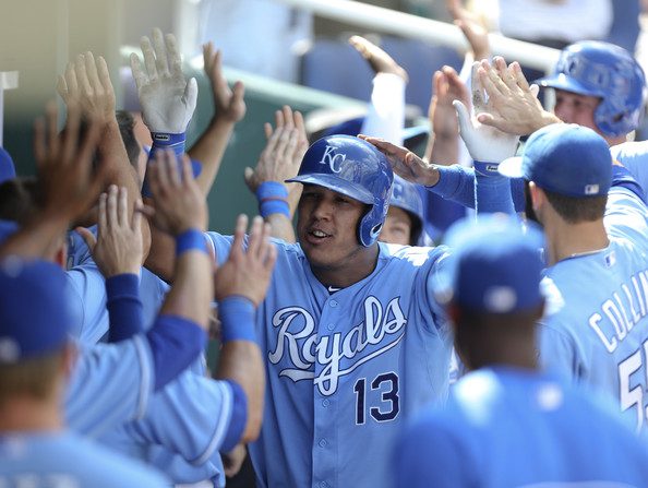 Salvador Perez gets high fives in the dugout.