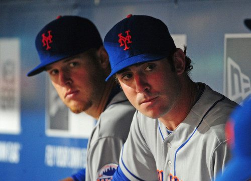 Zack Wheeler and Matt Harvey sitting on the Mets' bench.