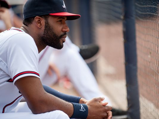Jason Heyward watches from the dugout.