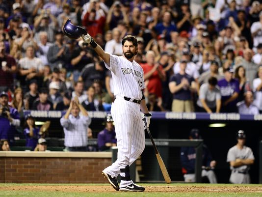 Todd Helton tips his cap to the fans right before belting a home run during the second inning of the Rockies 15-5 loss to the Red Sox.