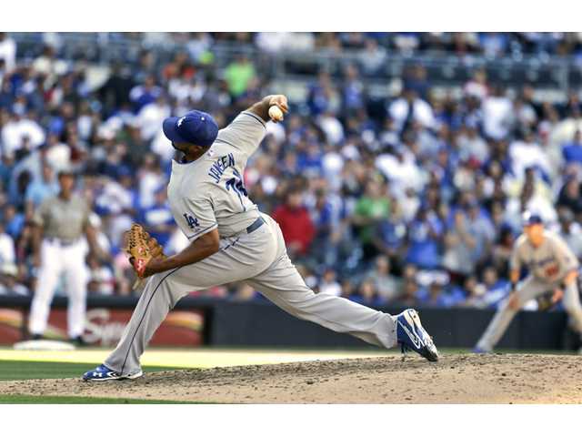 Los Angeles Dodgers closer pitcher Kenley Jansen fires a pitch against the Padres on Sunday in San Diego.
